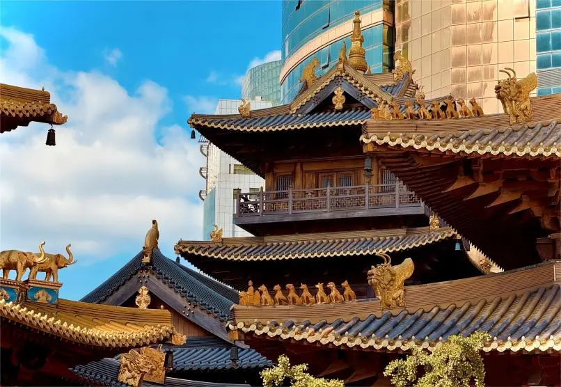 Architectural detail of Jing’an Temple in Shanghai under a sunny sky, showcasing Buddhist temple design