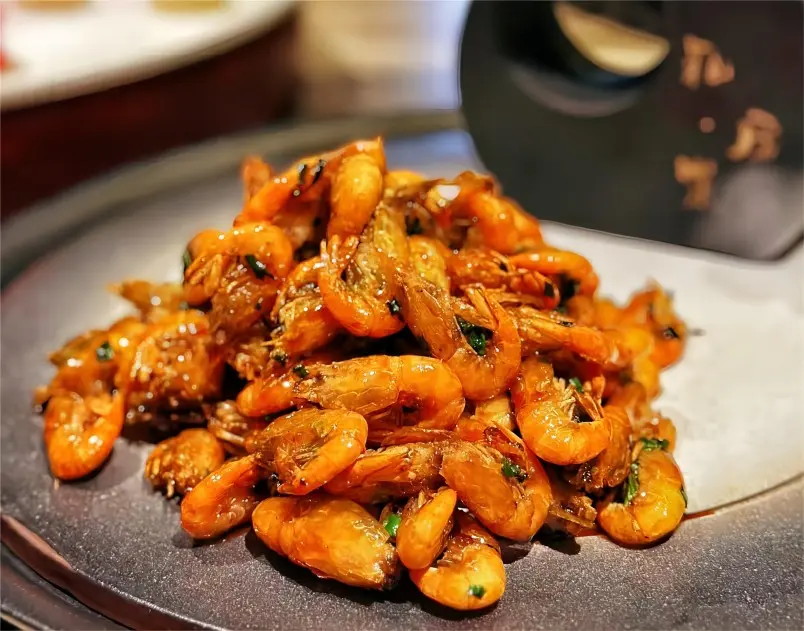 Traditional Shanghai Youbao Xia served on a plate, crispy shrimp with savory sauce