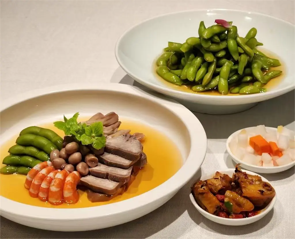 Shanghai-style drunken delicacies cold dish set including drunken chicken feet, peanuts, shrimp, abalone, edamame, and chicken gizzard.