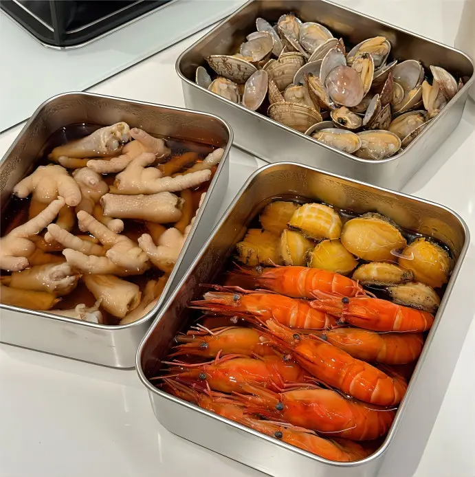 Mixed Shanghai Zao Huo drunken dishes featuring rice-wine marinated shrimp, chicken gizzard, chicken wings, abalone, and edamame.