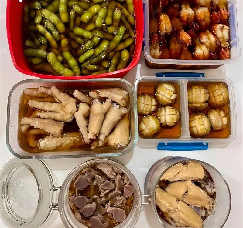 Assorted Shanghai Zao Huo drunken delicacies platter with edamame, chicken feet, shrimp, abalone, peanuts, and chicken wings.