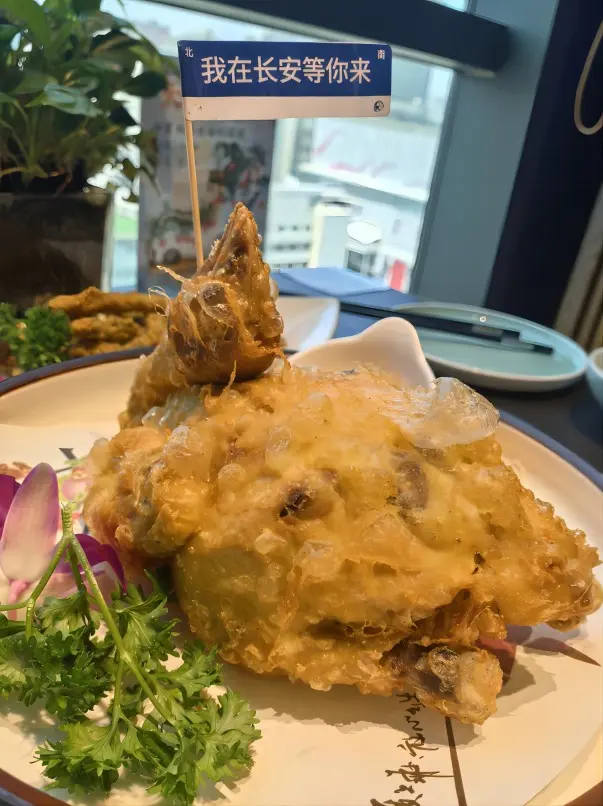 A whole Xi’an Gourd Chicken (Hulu Chicken) served on a plate, showing crispy golden skin