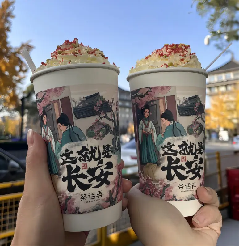 A traveler holding Cha Hua Nong milk tea on the street, one of the most popular trendy drinks in Xi’an