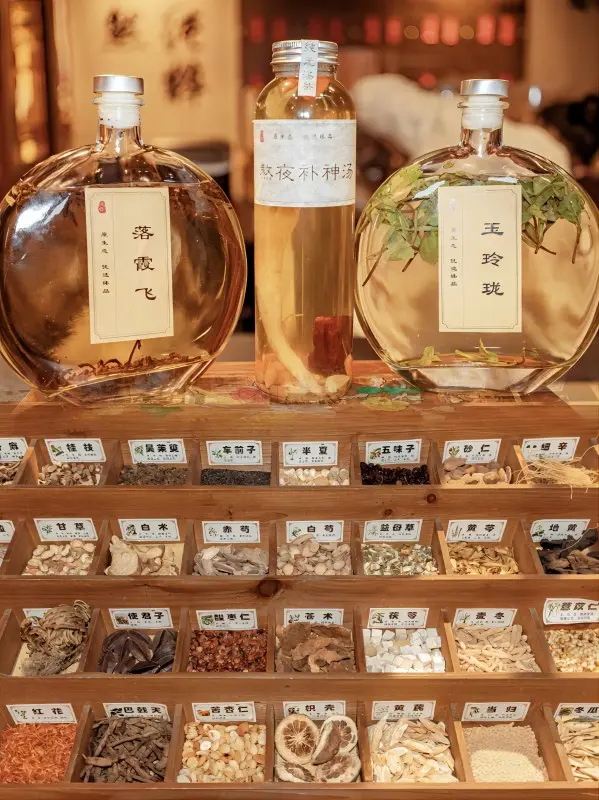 Tea drinks and traditional herbal ingredients displayed at Tang Shi Liang Yin, a creative modern drink shop in Xi’an