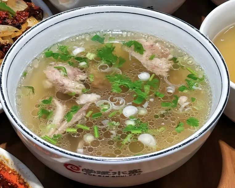 Thinly sliced lamb in Xi’an Shuipen Lamb Soup, showing tender meat and light broth
