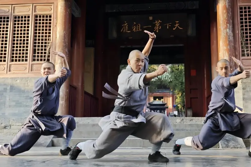 Shaolin monks performing traditional Kung Fu in front of the "First Ancestral Hall" plaque at Shaolin Temple, Henan