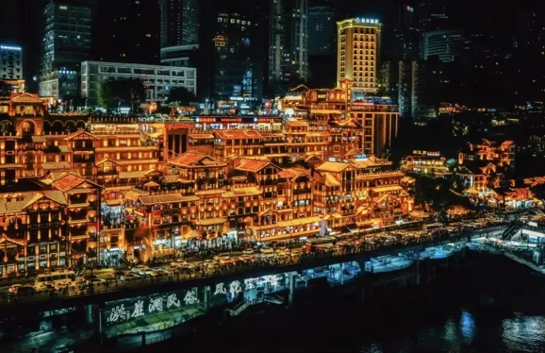 Hongyadong night view in Chongqing with glowing traditional stilt buildings