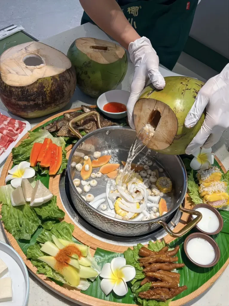 Traditional Sanya coconut chicken hotpot, served with fresh coconut broth and Wenchang chicken