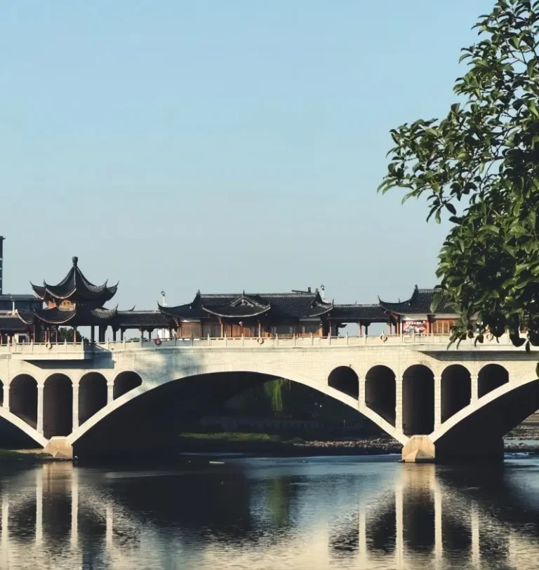 A scenic view of the antique stone bridge in Fotang Ancient Town, Yiwu, illustrating traditional Jiangnan water town architecture.