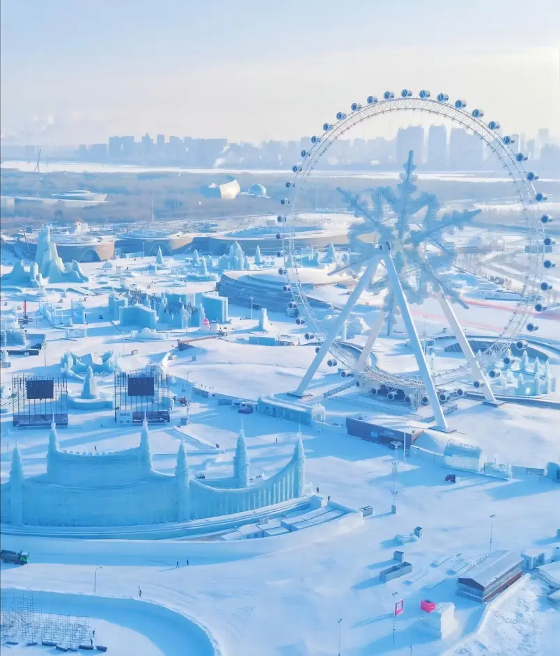 Aerial view of Harbin Ice and Snow World during the day with massive ice sculptures