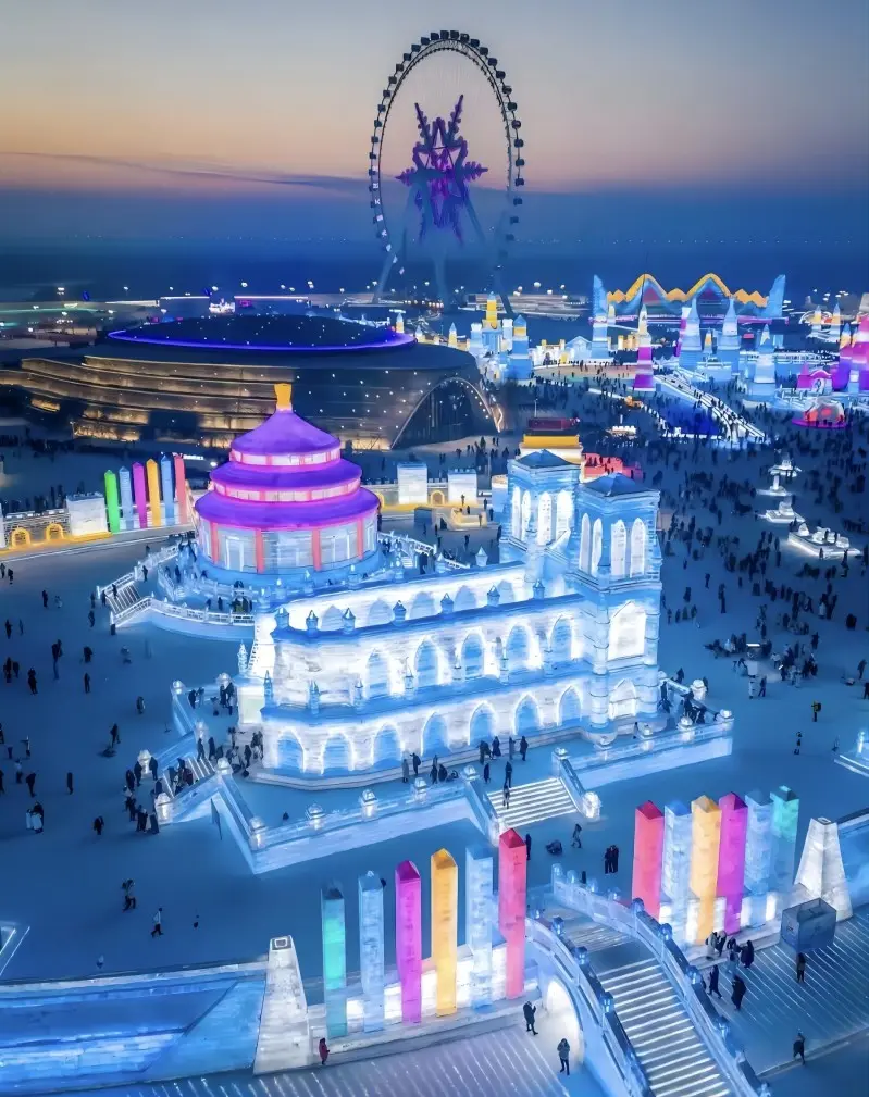 Night aerial view of Harbin Ice and Snow World illuminated with colorful lights