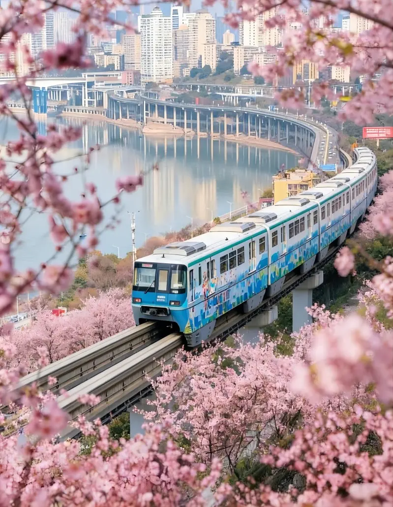 Liziba Station surrounded by blooming flowers in spring with train passing through building