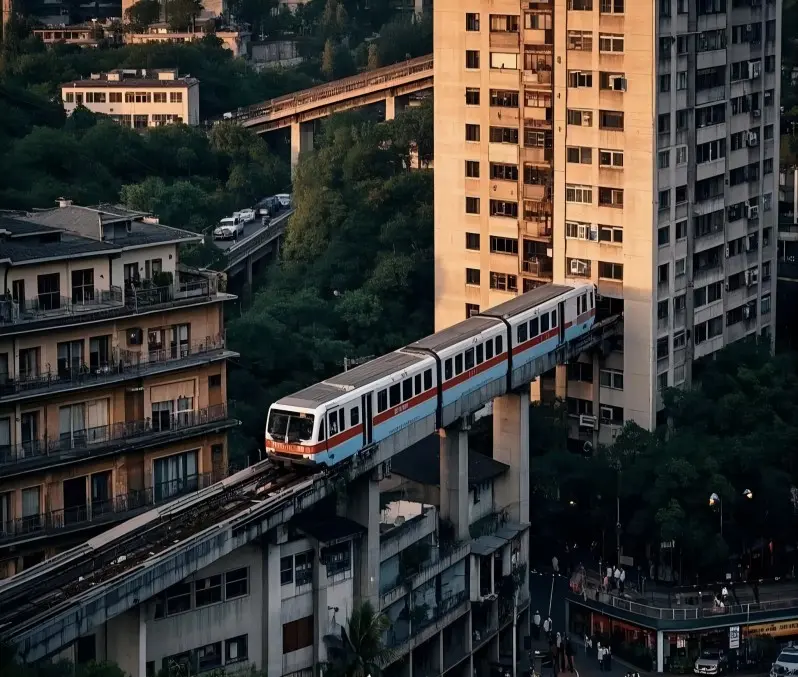 Light rail train passing through building at Liziba Station during sunset in Chongqing