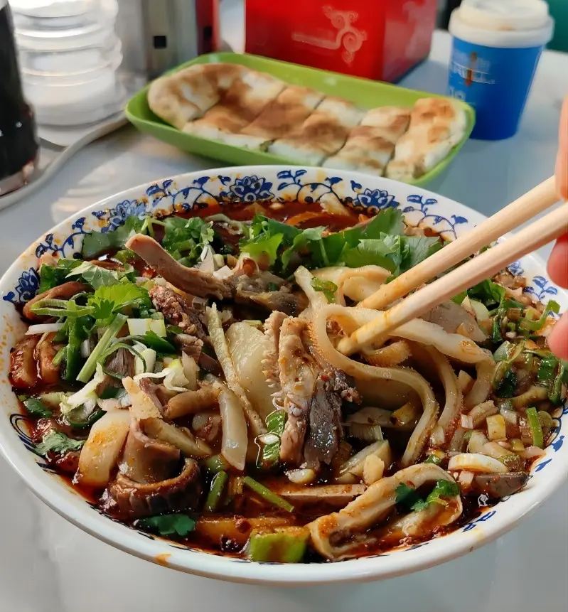 A bowl of braised lamb offal, a warming local dish made with lamb heart, liver, and intestines in a rich broth.