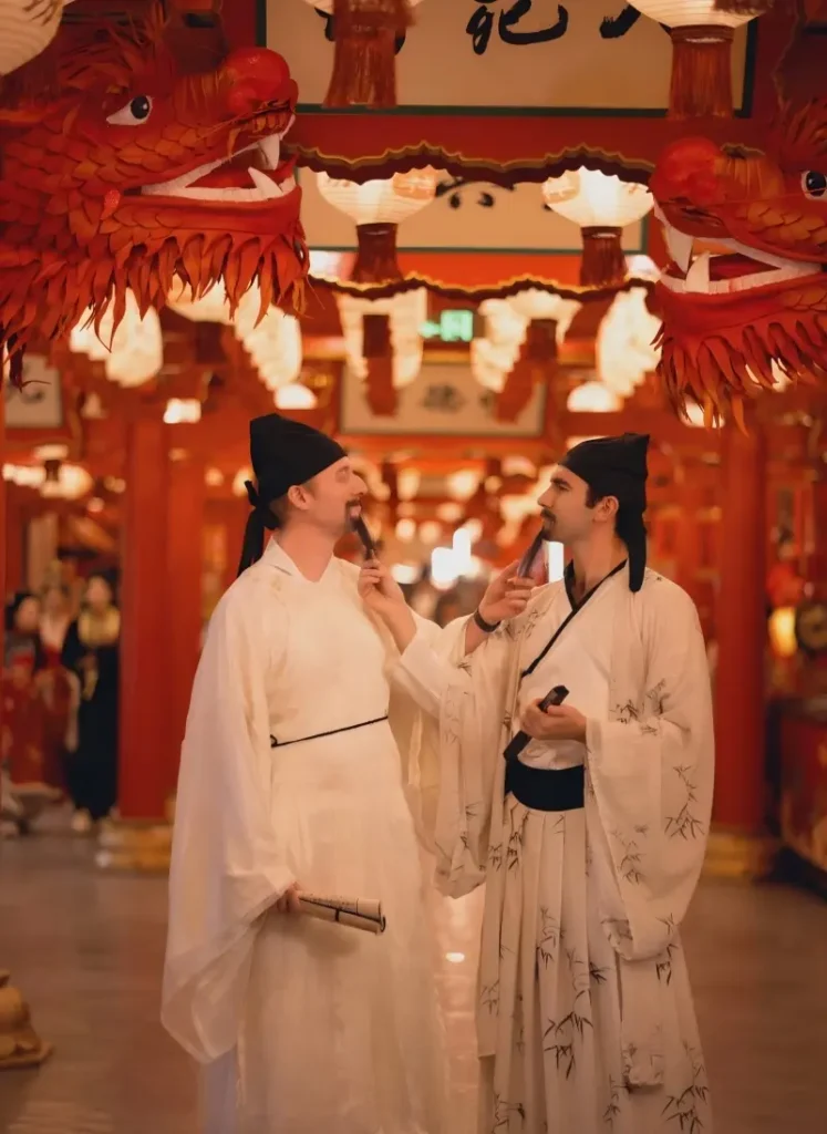 Foreign tourists wearing Hanfu at Chang’an Twelve Hours Theme Street in Xi’an experiencing Tang Dynasty cultural immersion