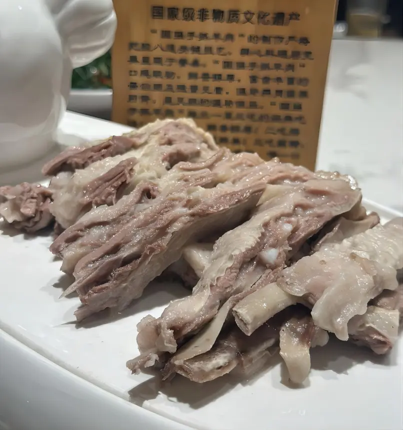 A traditional plate of Ningxia Tan Lamb, known for its tender and gamey-free meat, served hand-pulled with a simple salt dip.