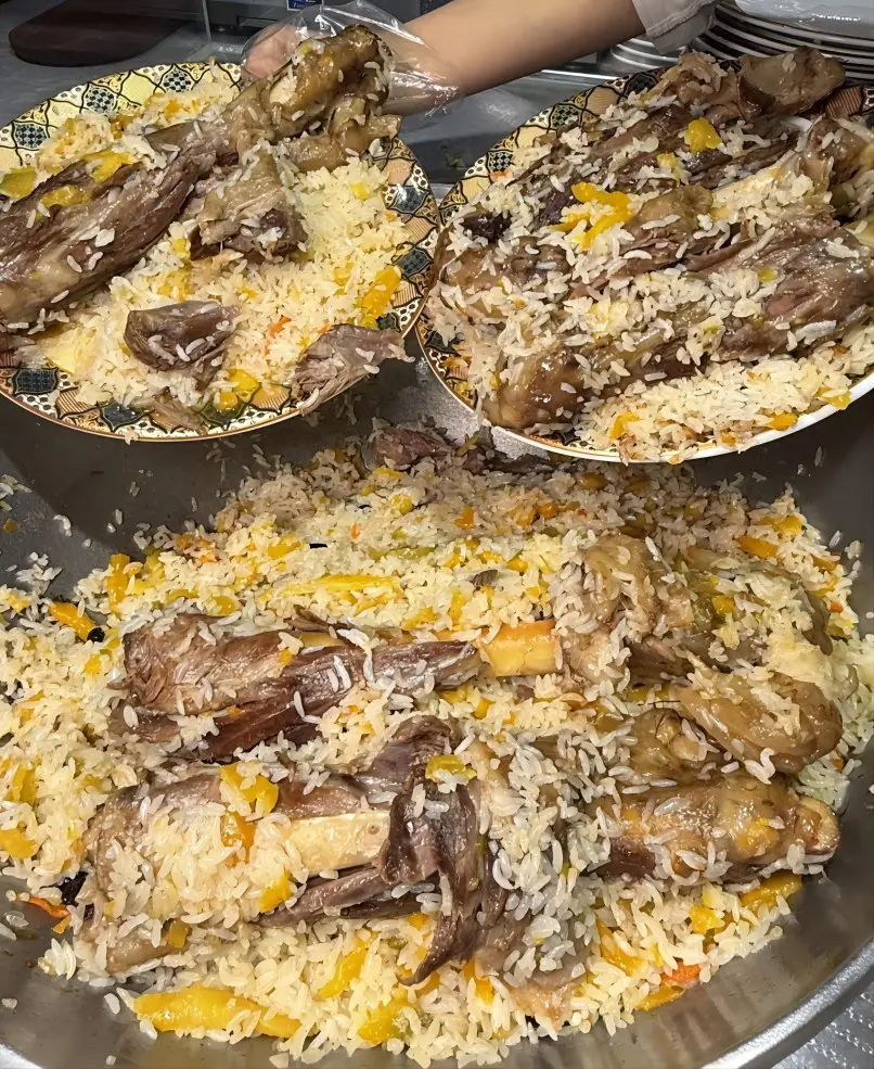 Traditional hand-pulled rice (Boro) with lamb, carrot, and onion, a must-try dish in Yining
