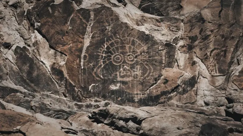 Close-up view of ancient rock paintings at Helan Mountain, depicting early human life and rituals.