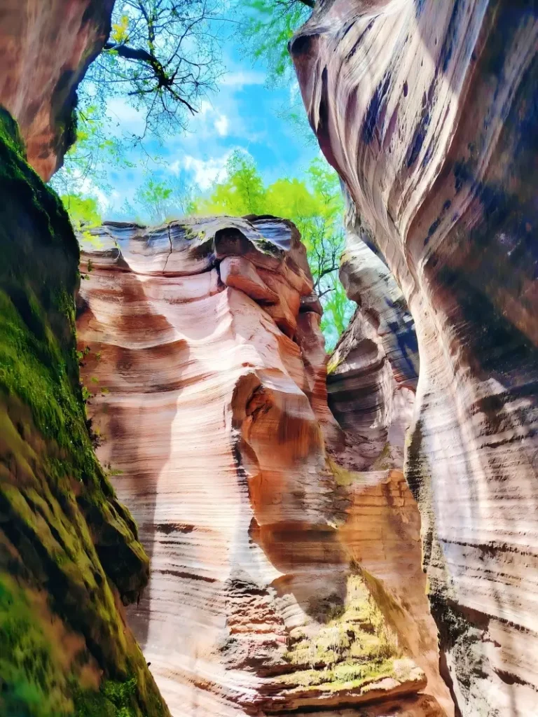 Wave-shaped red sandstone cliffs at Yucha Grand Canyon on a sunny day