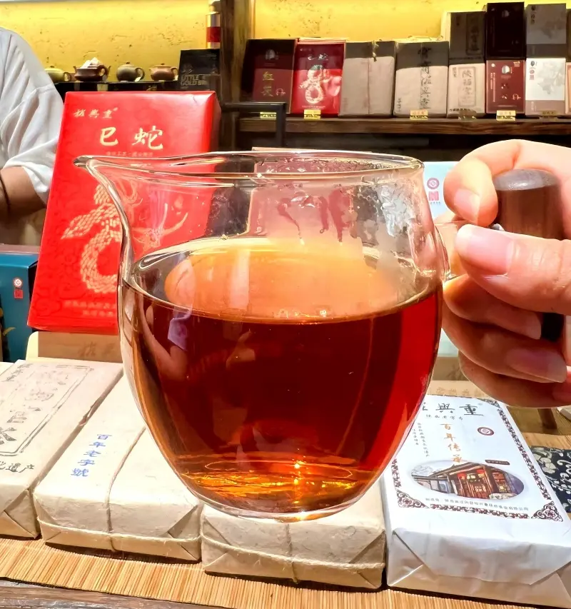 Close-up of brewed Fucha tea with amber-orange tea liquor