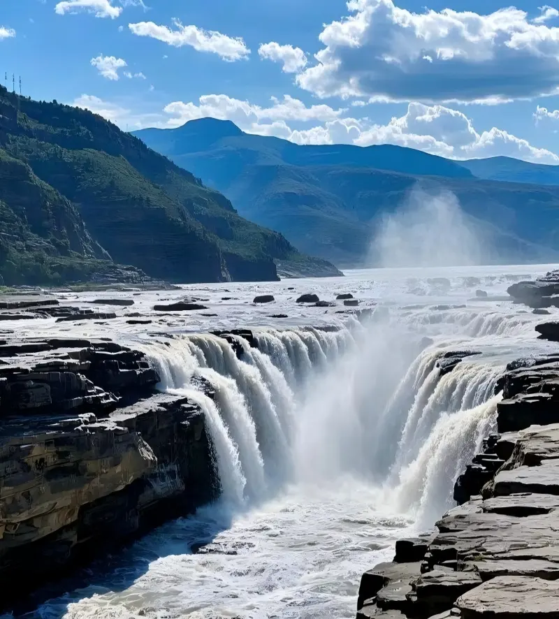 A panoramic view of Hukou Waterfall as the Yellow River narrows dramatically before plunging into the gorge.