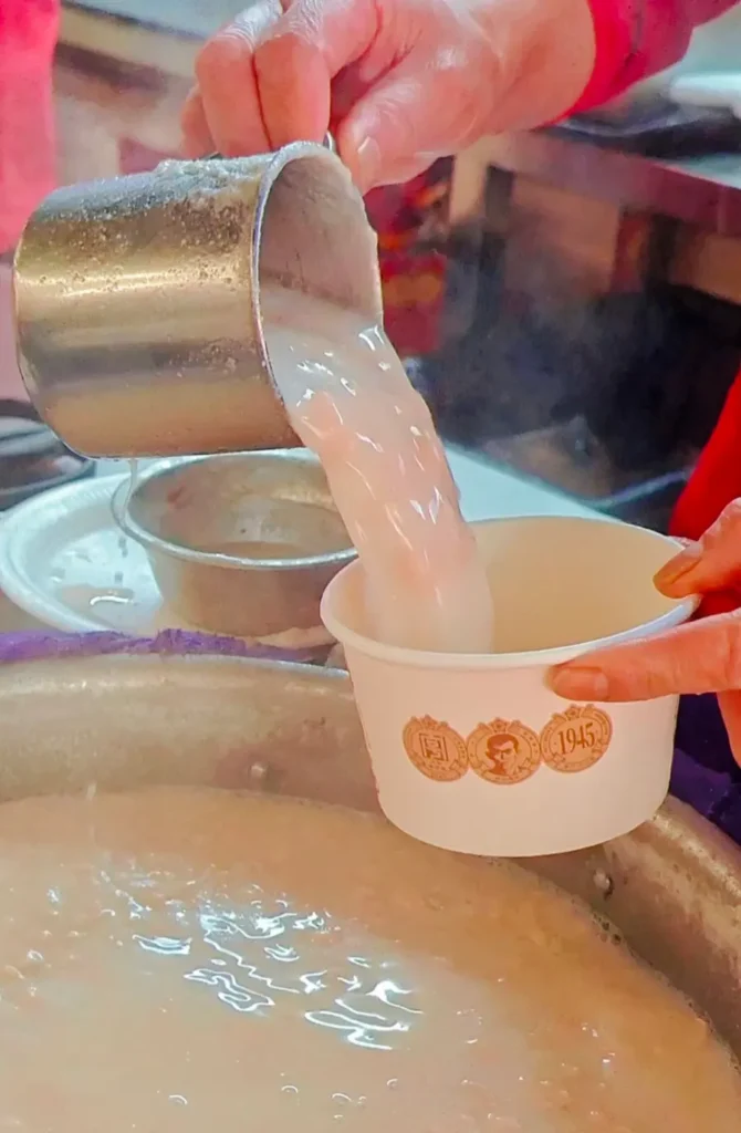 A local vendor serving peanut soup at Bashi Market in Xiamen, China