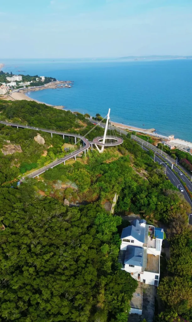 Aerial view of Huandao Road coastline in Xiamen with the sea and city landscape