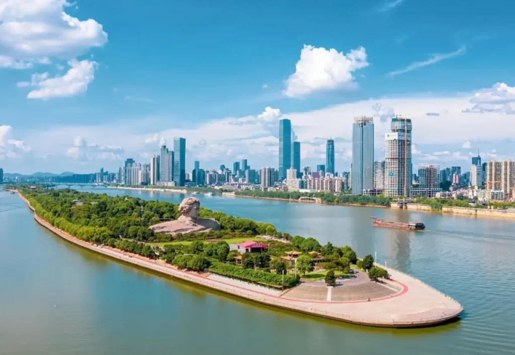 Aerial view of Orange Isle in the Xiangjiang River in Changsha, with green parkland and the city skyline.