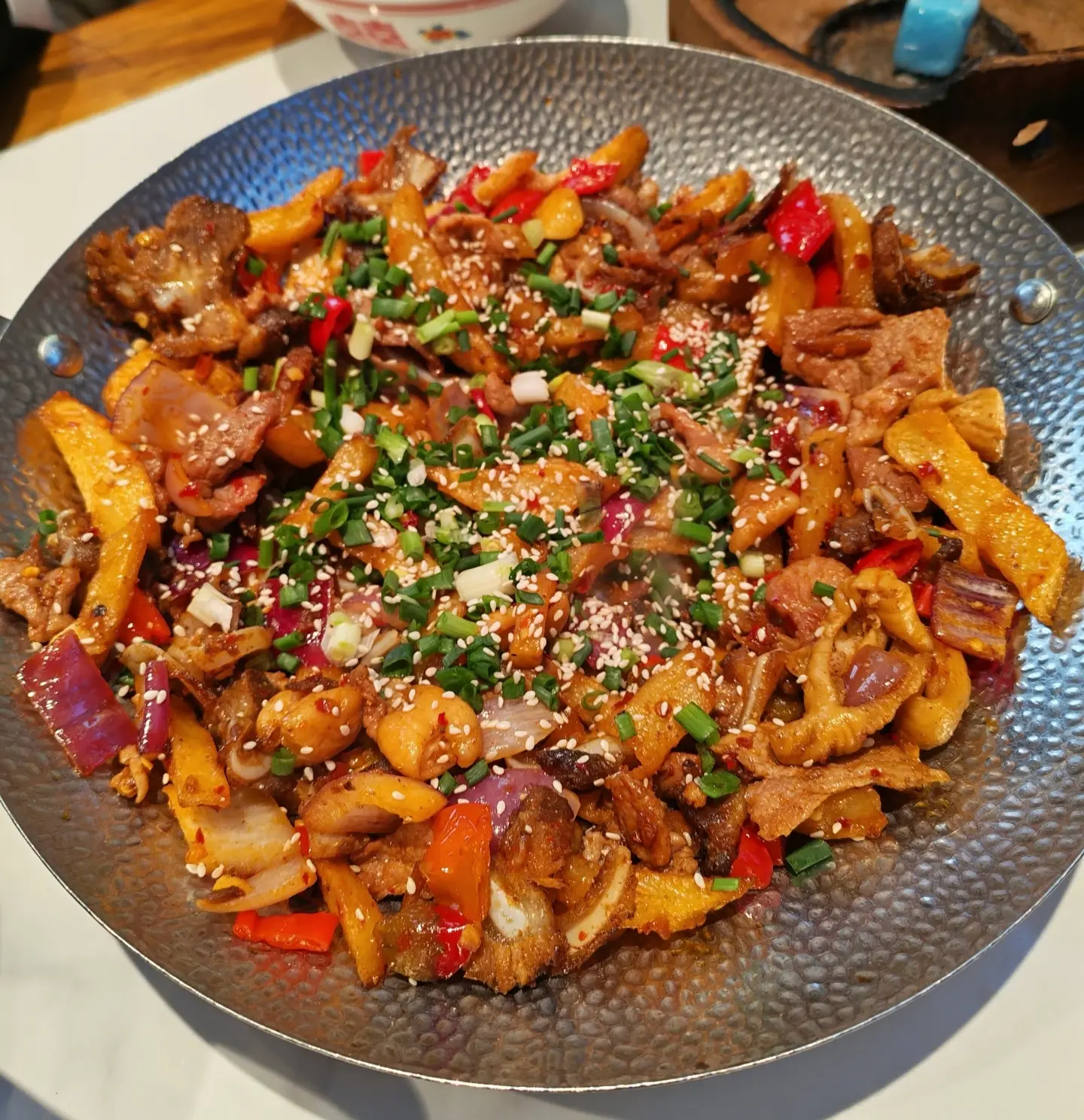 Close-up view of Sanxia Guo (Three-in-One Stew), a spicy and savory traditional Zhangjiajie dish simmered in a pot.
