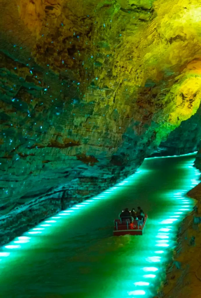 Tourists taking a boat cruise along the underground river inside Huanglong Cave, Suoxiyu