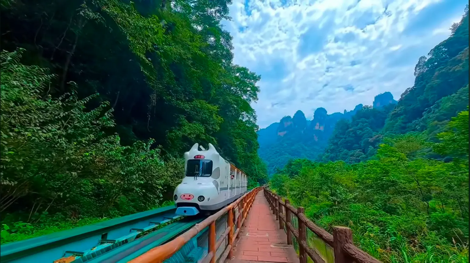 Sightseeing train carrying tourists through the Ten-Mile Gallery valley in Suoxiyu, Zhangjiajie