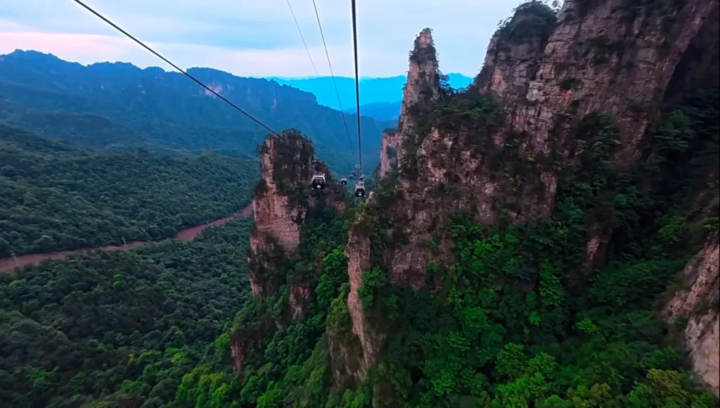 Tianzi Mountain Cable Car cabin gliding past sandstone peak forests in Wulingyuan